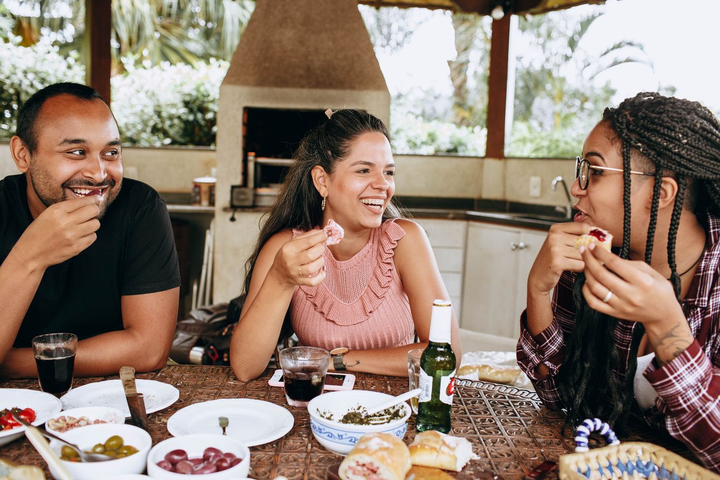 Stock photograph of friends sharing a meal outdoors.