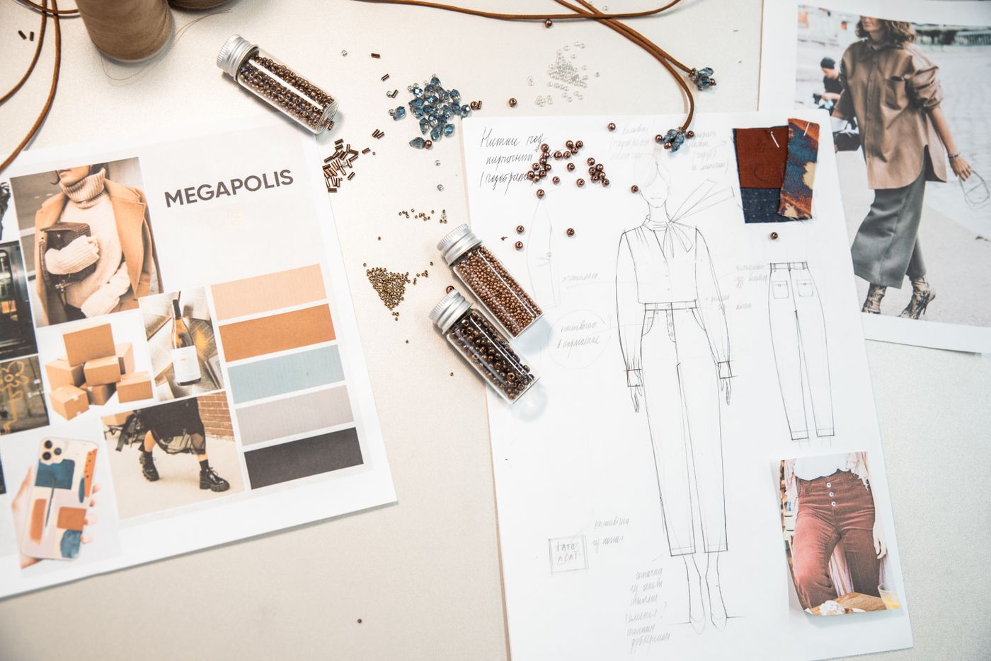 Stock photograph of a creative workspace with sketches and a design mood board.