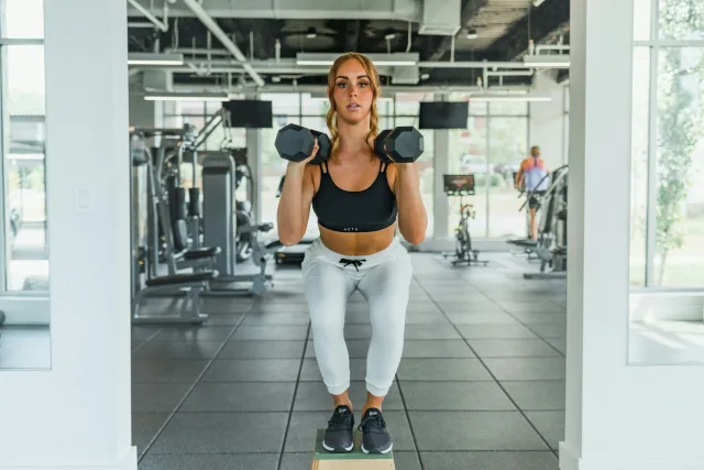 Dumbbell training in a bright gym